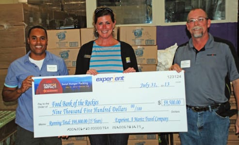 Yurii Land (left) and Gary Schirmacher (right), Experient, present the $9,500 check to Kim Ruotsala (center) VP of development at the Food Bank of the Rockies