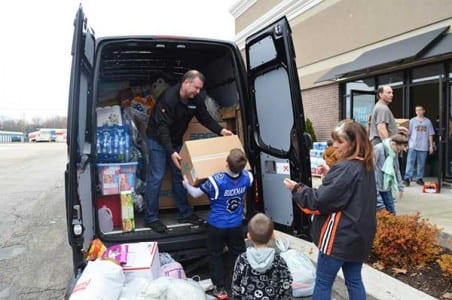 Ken Buckman and family uploading supplies in Washington, Ill.