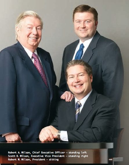 Robert A. Wilson, Chief Executive Officer – standing left Scott R. Wilson, Executive Vice President – standing right Robert W. Wilson, President – sitting