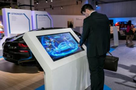 A visitor explores the BMW i8’s features via an X-ray touch-screen panel at the Future of Mobility zone