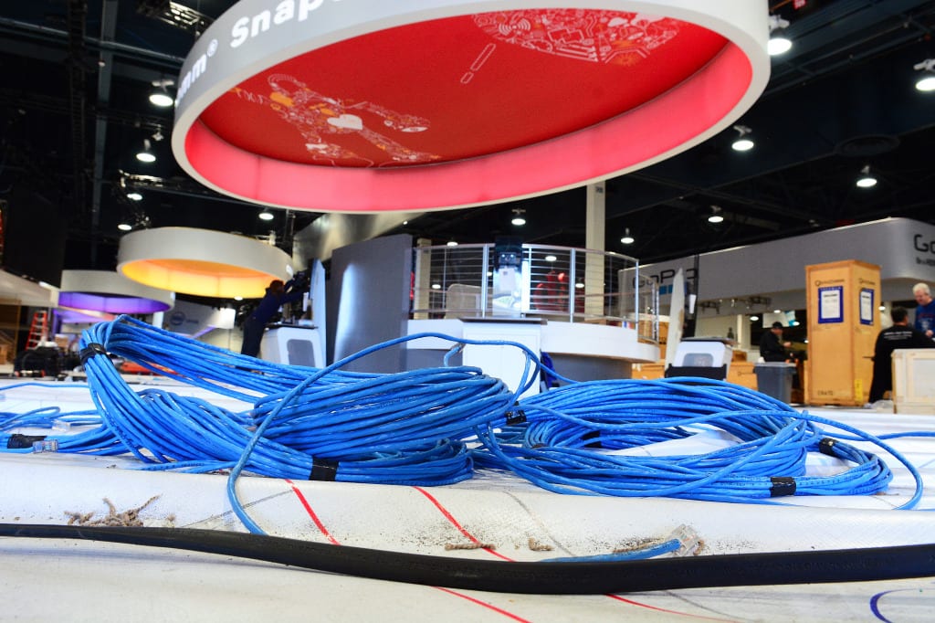 Bundles of CAT 5 Ethernet cable are pre-staged for deployment inside a vendor booth at CES by Cox Business installation technicians.