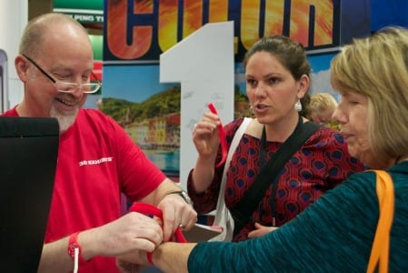 Jeff Bartle of 3D Exhibit helps visitors put on their RFID/NFC wristbands at EXHIBITORLIVE 2015.