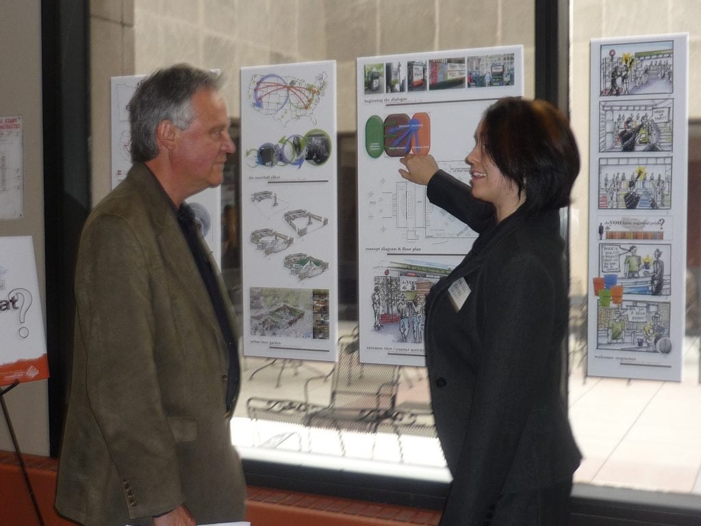 Former 3D Exhibits Senior Vice President Larry Kulchawik critiquing student thesis project.