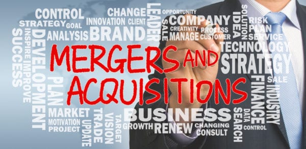 mergers and acquisitions concept with business word cloud handwritten by businessman