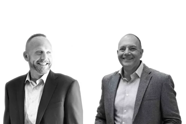 Jason Weddle and Rob Cohen standing in professional attire.