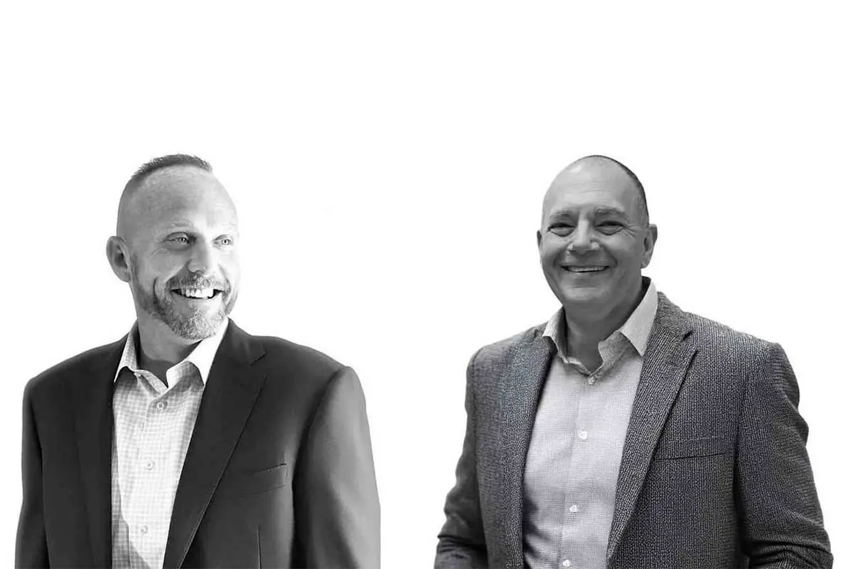 Jason Weddle and Rob Cohen standing in professional attire.