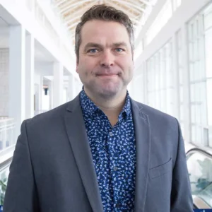 A headshot of Erik Hudson