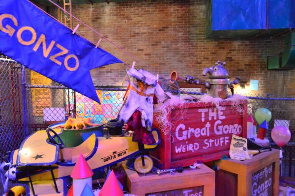 Colorful Gonzo-themed props, crates, and signs are displayed inside the queue for Rock ‘n’ Roller Coaster Starring The Muppets at Disney’s Hollywood Studios.