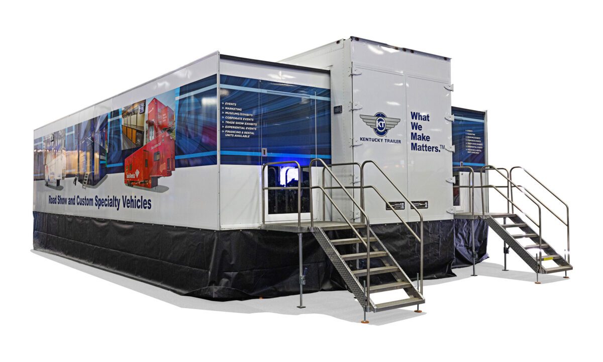 Kentucky Trailer Specialty Vehicles show trailer with stairs and branded exterior graphics.