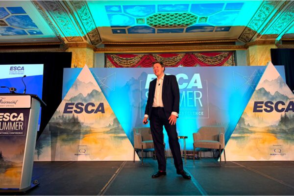 Alexander Easdale speaks onstage during the ESCA Summer Educational Conference in Banff.