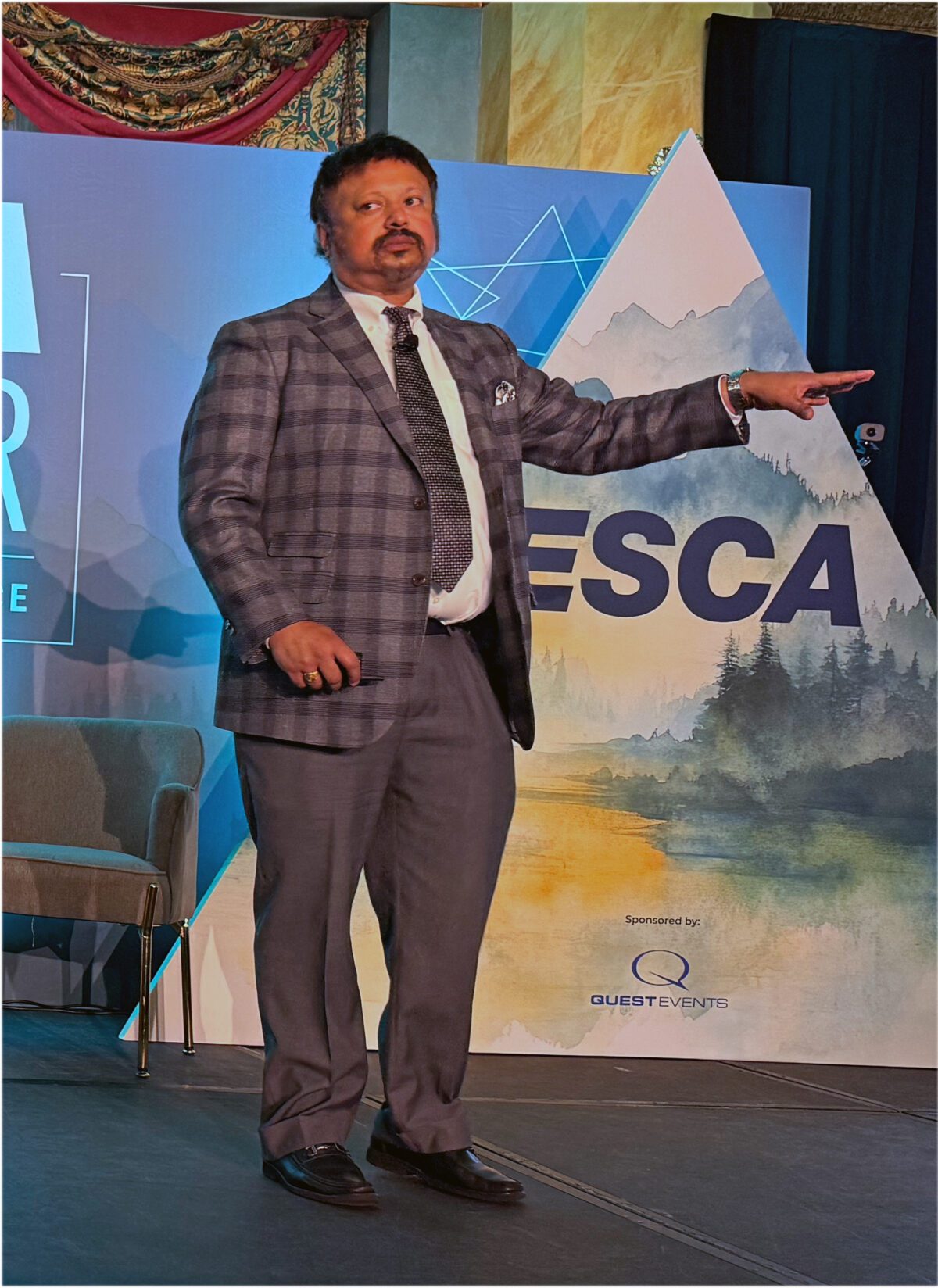 Anirban Basu speaks onstage during the ESCA Summer Educational Conference in Banff.