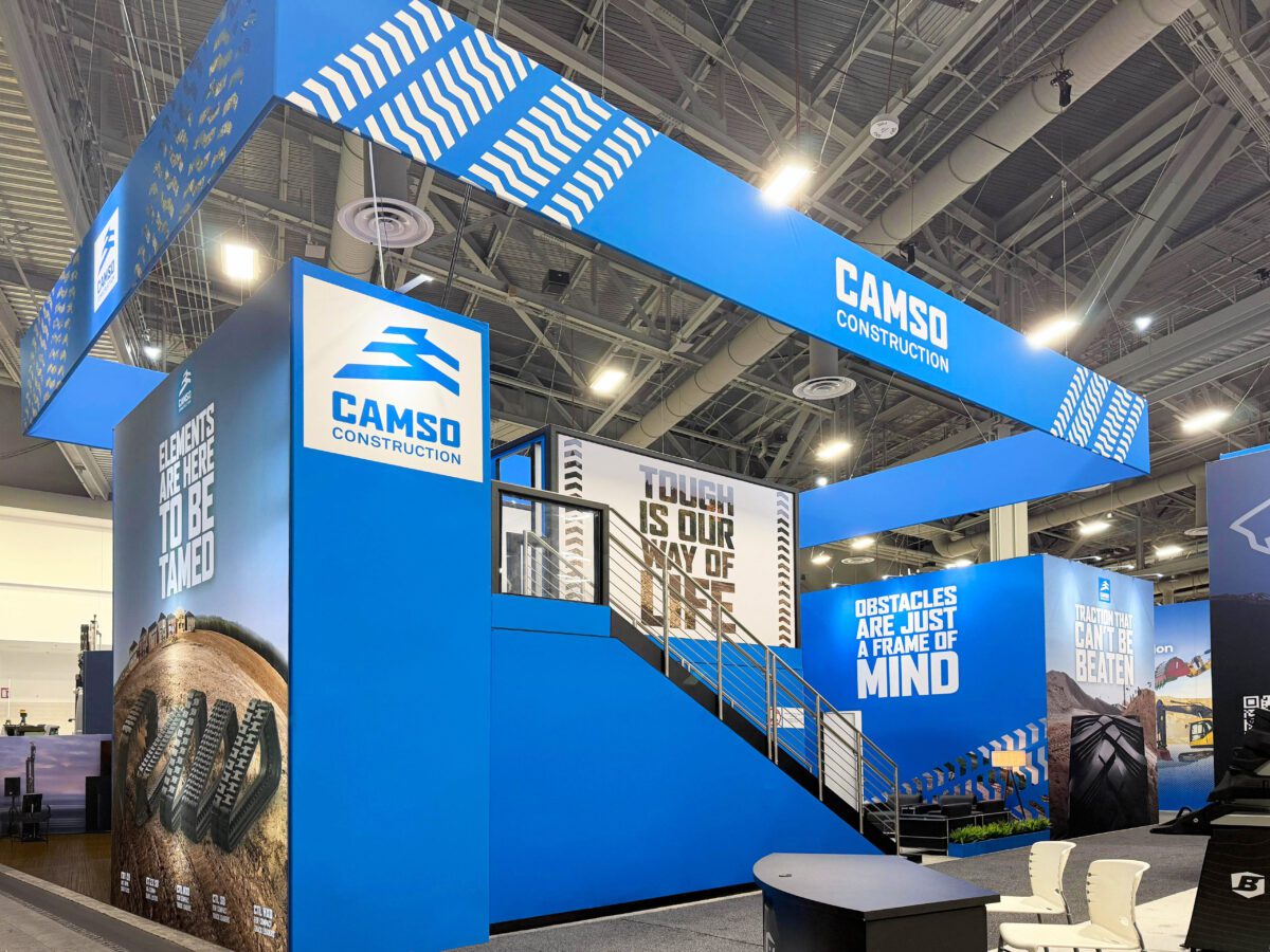 Camso double-deck exhibit with stairs, overhead signage, and branded graphics at CONEXPO-CON/AGG.