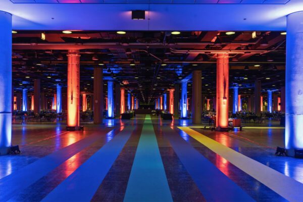 Interior event space at McCormick Place with colorful lighting and wide walkways.