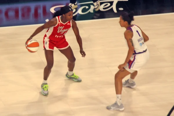 Las Vegas Aces All-Star Jackie Young dribbles against Phoenix Mercury defender Noémie Brochant