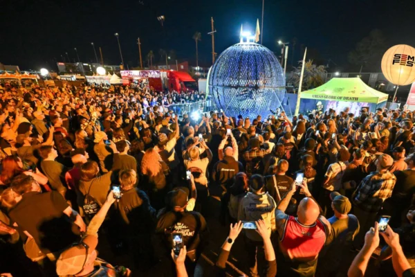 Crowd watches the Globe of Death stunt show during SEMA Fest