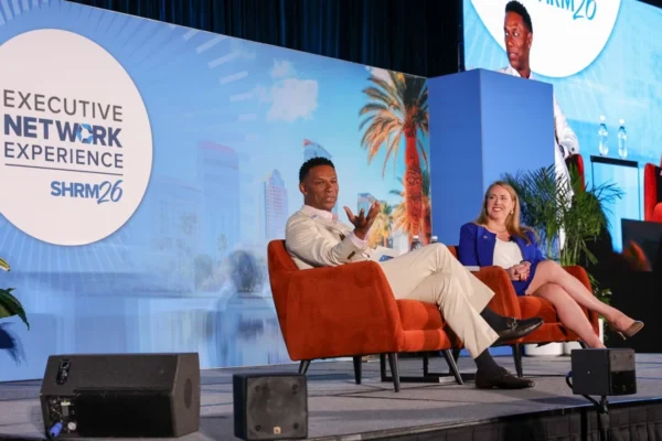 SHRM President and CEO Johnny C. Taylor Jr. speaks with EEOC Chair Andrea Lucas during SHRM26 in Orlando