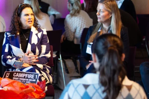 Attendees participate in a small-group discussion during a live event.