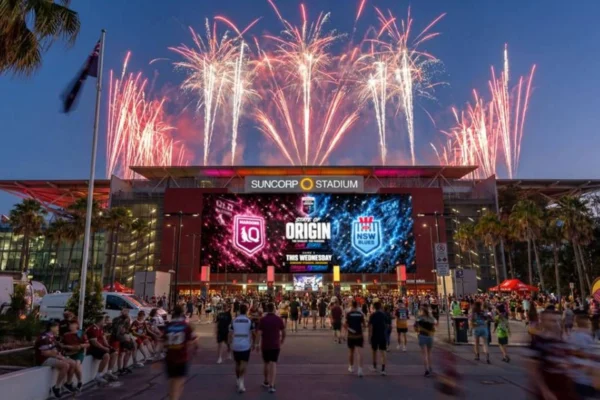 Crowds gather outside Suncorp Stadium during a fireworks display.